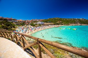 Spiaggia di Rena Bianca beach with red rocks and azure clear water, Santa Terasa Gallura, Costa Smeralda, Sardinia, Italy.