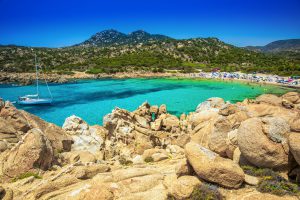 Cala Cipolla, Chia beach with red stones and azure clear water. Sardinia is the second largest island in the Mediterranean Sea.