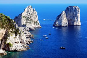Faraglioni rocks close the Capri island in Italy with a beautiful blue sea color.